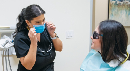 dentist-standing-next-to-dental-patient-during-dental-exam